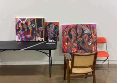 Three paintings, two of them representing dark skinned women.